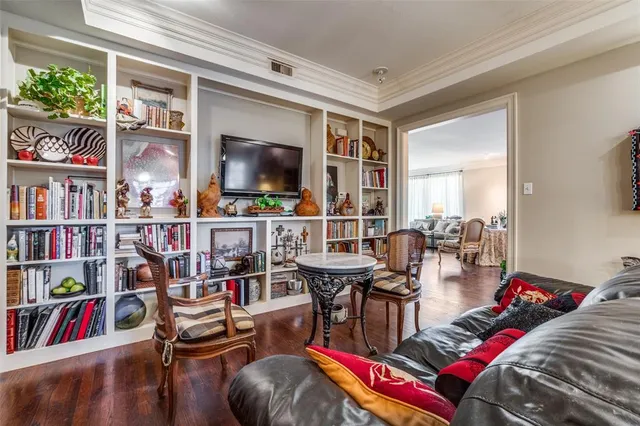 a living room with furniture and a book shelf