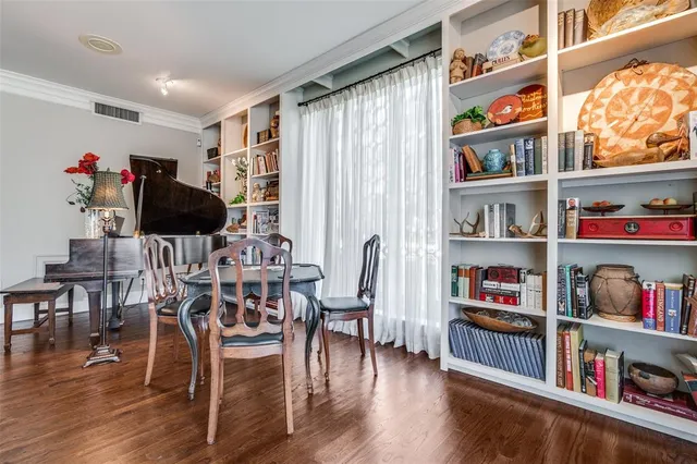 a living room with furniture and a book shelf