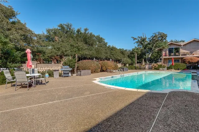 a view of a house with swimming pool and sitting area