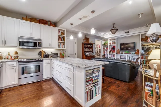 a kitchen with stainless steel appliances granite countertop a stove and a sink