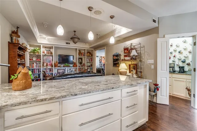 a kitchen with stainless steel appliances kitchen island granite countertop a sink and cabinets