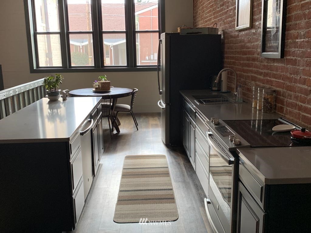 358 East Main Street Dayton, WA 99328 - Photo 2 of 34 a hallway with a stove a washer and dryer
