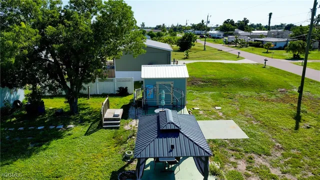 an aerial view of a house with swimming pool garden and outdoor seating