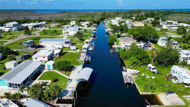 an aerial view of residential houses with outdoor space and trees