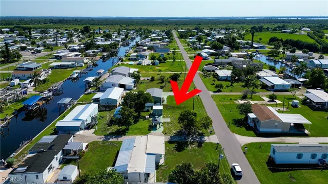 an aerial view of a house with garden space and street view