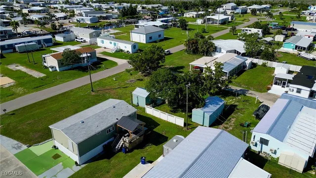 an aerial view of residential houses with outdoor space and street view