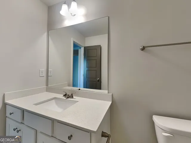 a white toilet and tub next to a bathroom sink