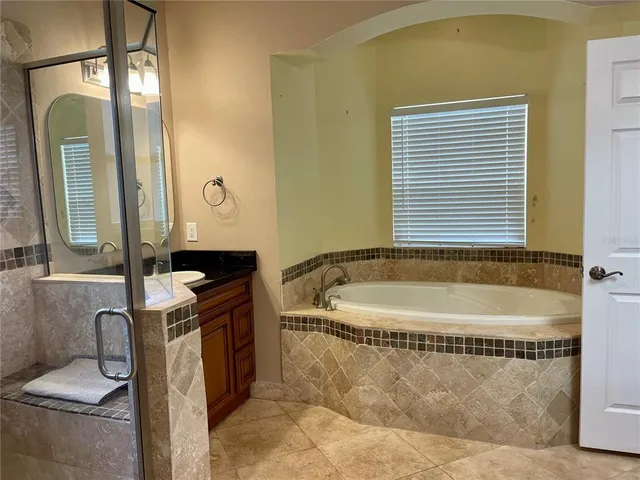 a bathroom with a bathtub and a shower