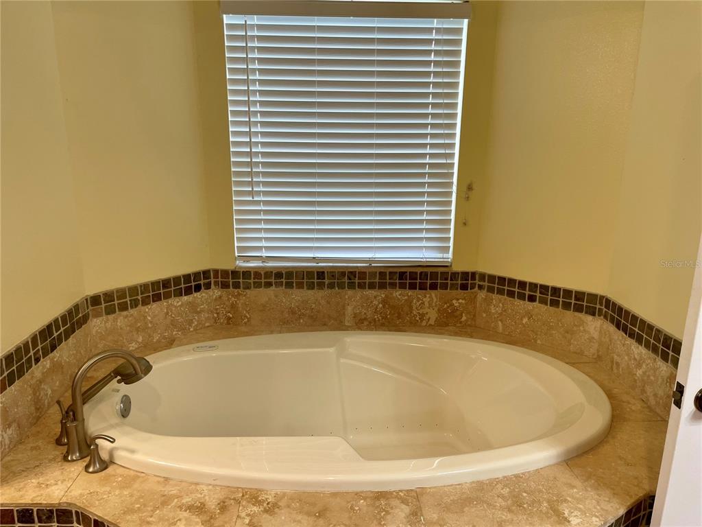 2564 Islander Court Palm Harbor, FL 34683 - Photo 14 of 21 a white bath tub sitting in a bathroom