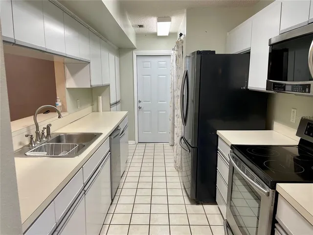 a kitchen with a stove and a microwave