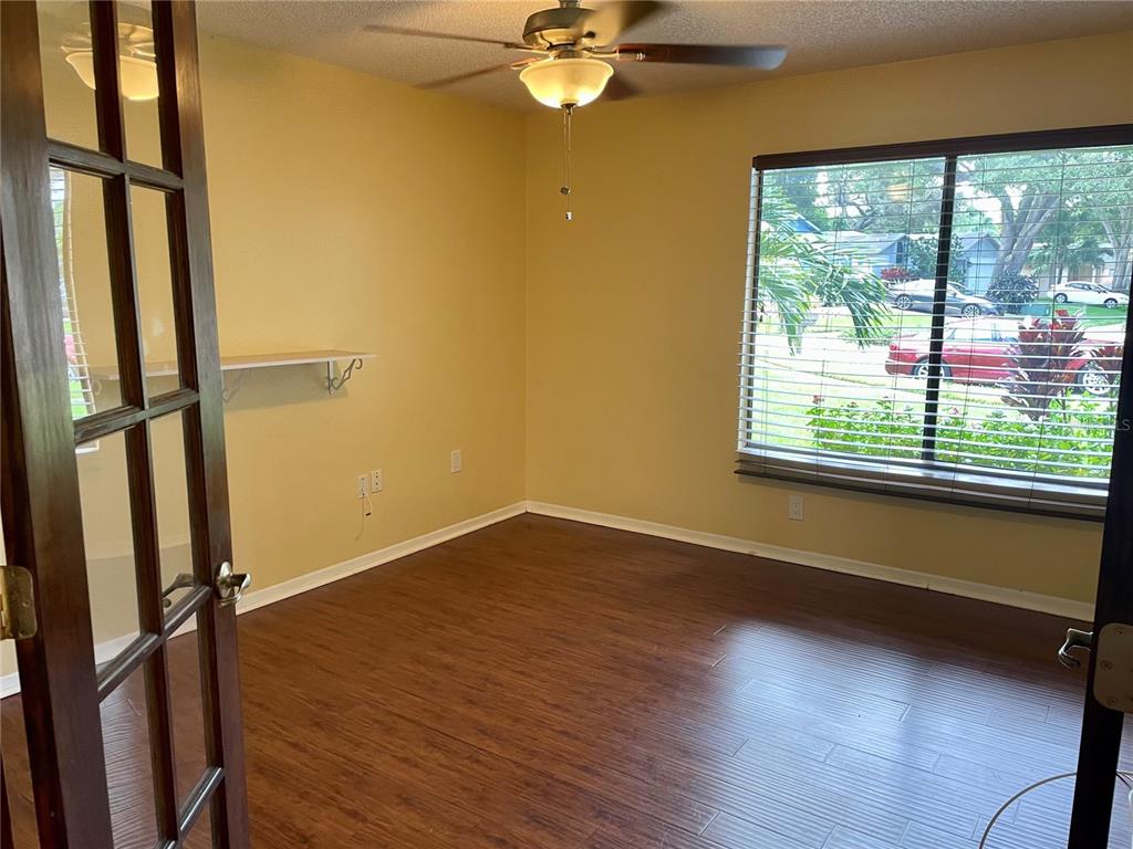2564 Islander Court Palm Harbor, FL 34683 - Photo 9 of 21 a view of an empty room with wooden floor and a window