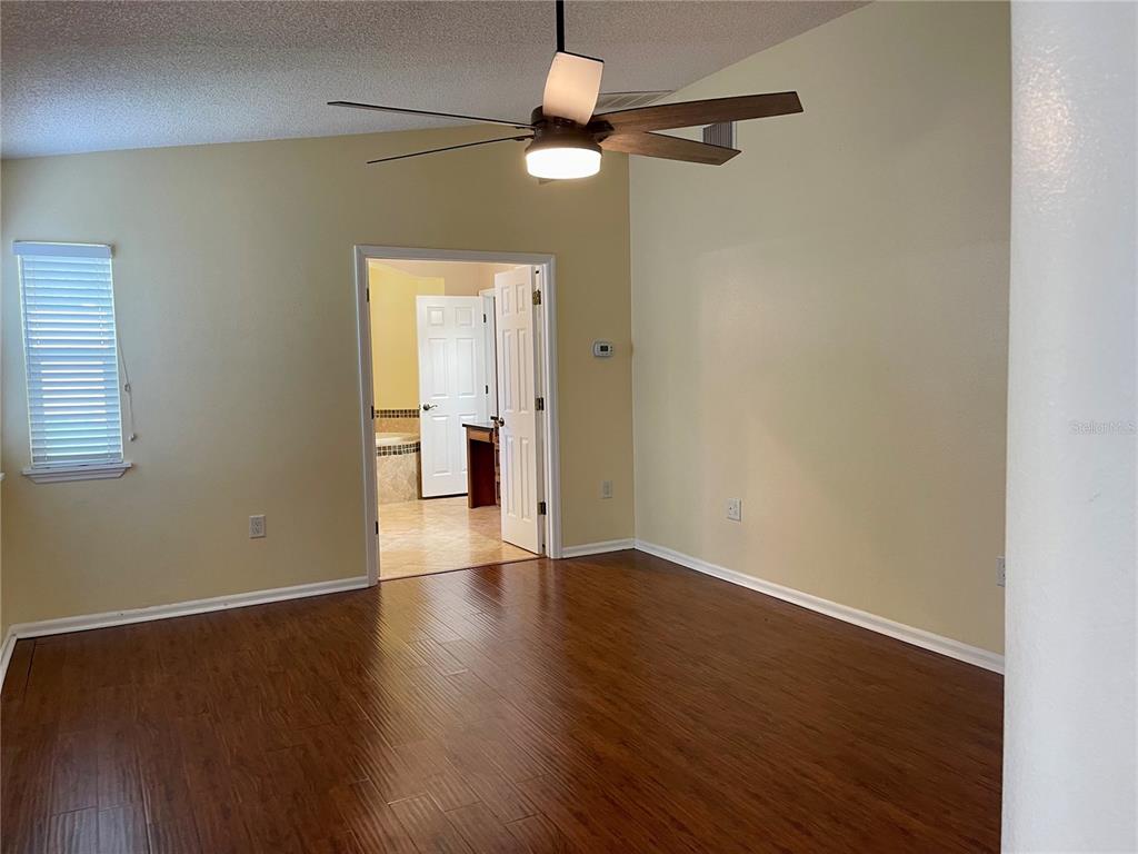 2564 Islander Court Palm Harbor, FL 34683 - Photo 10 of 21 a view of an empty room with wooden floor and a window