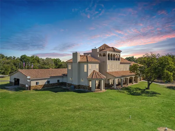 a view of a big house with a big yard