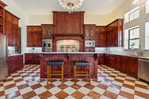 a kitchen with stainless steel appliances granite countertop a sink and cabinets