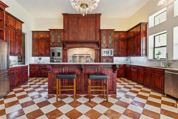 a kitchen with stainless steel appliances granite countertop a sink and cabinets