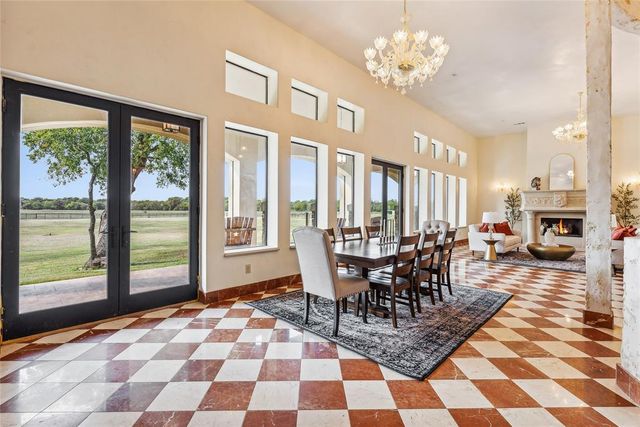 a living room with a black white checkered floor with couches chair and a coffee table