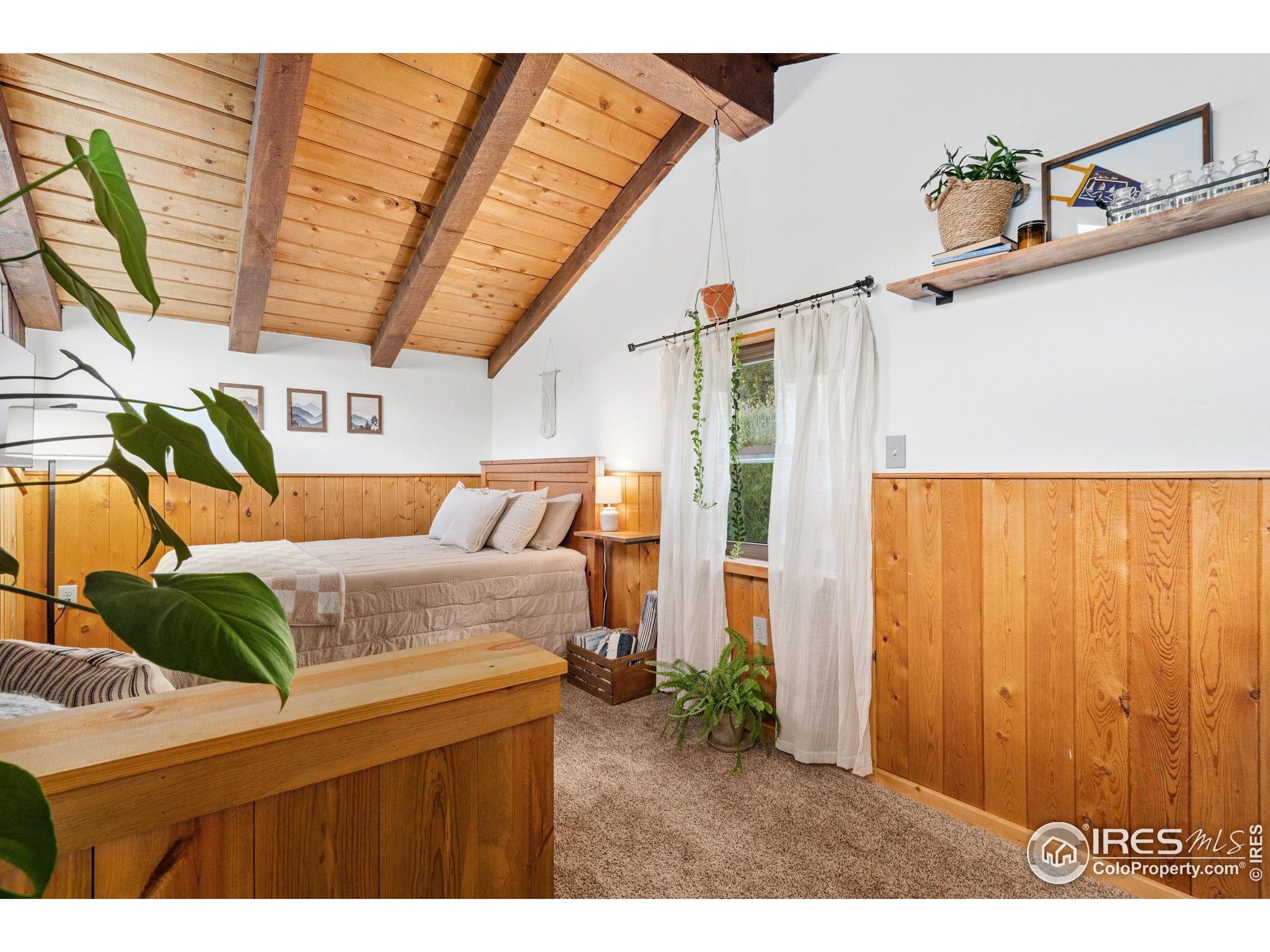 32224 Poudre Canyon Road Bellvue, CO 80512 - Photo 17 of 34 a bedroom with furniture and a window