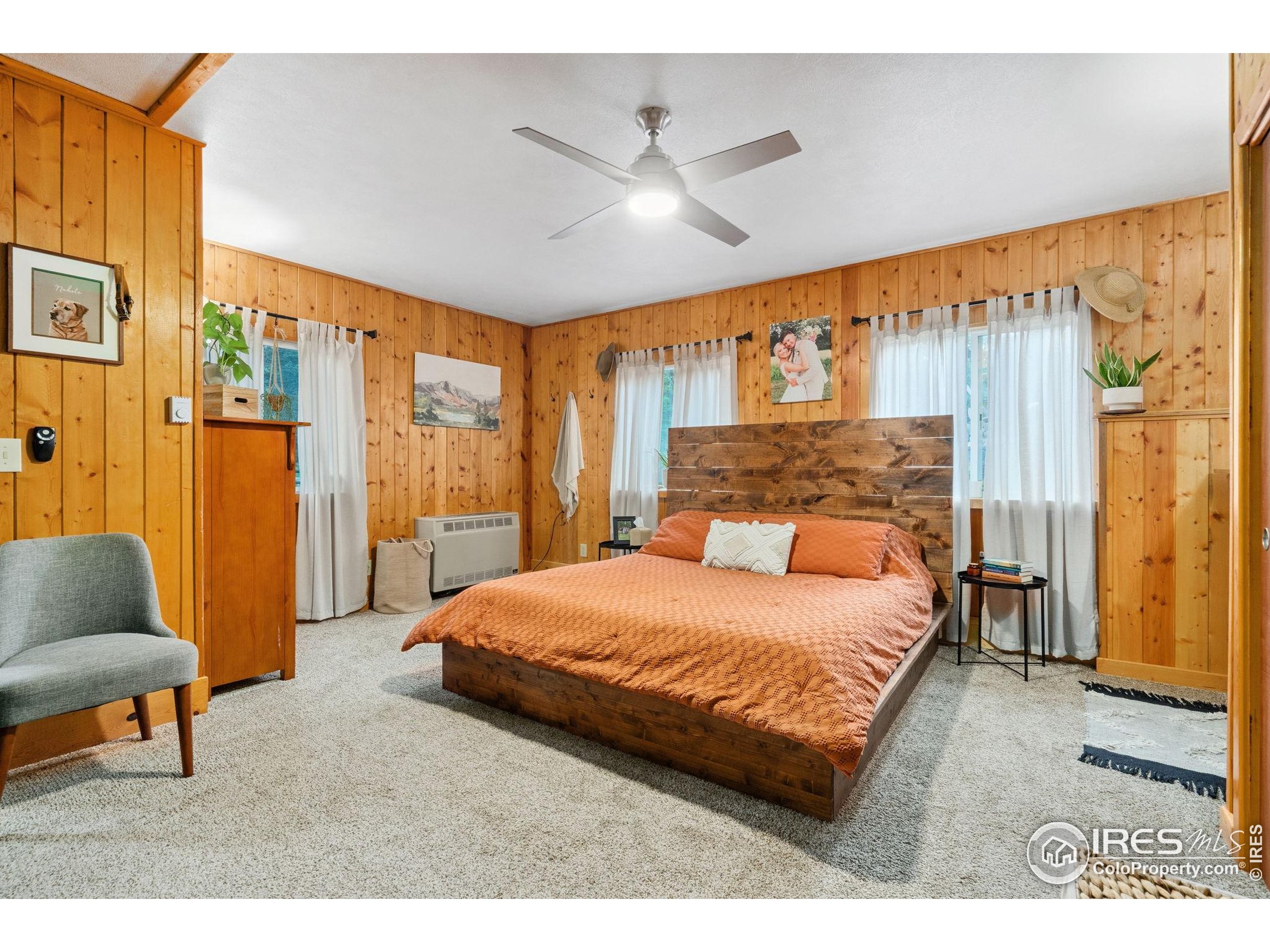 32224 Poudre Canyon Road Bellvue, CO 80512 - Photo 18 of 34 a bedroom with a bed and a couch