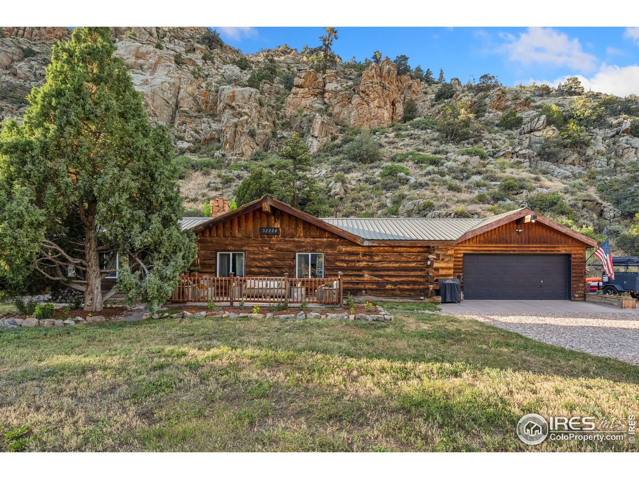 32224 Poudre Canyon Road Bellvue, CO 80512 - Photo 2 of 34 a backyard of a house with table and chairs