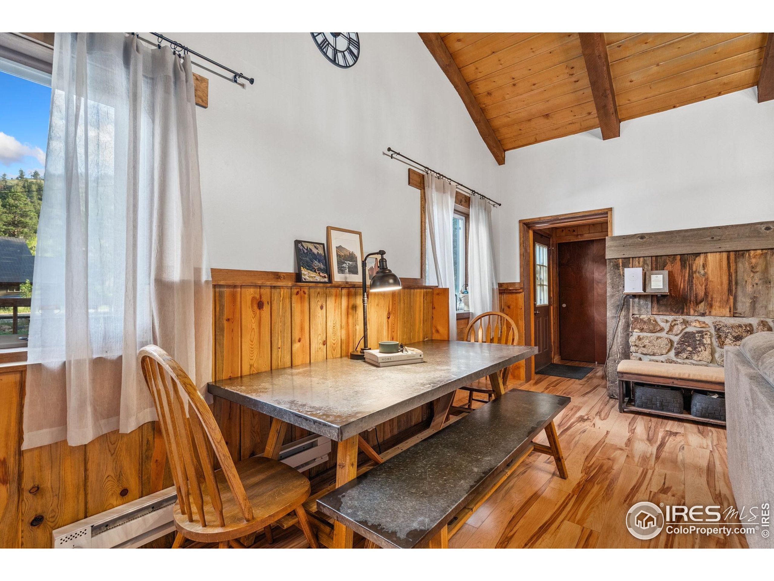 32224 Poudre Canyon Road Bellvue, CO 80512 - Photo 21 of 34 a living room with furniture and wooden floor