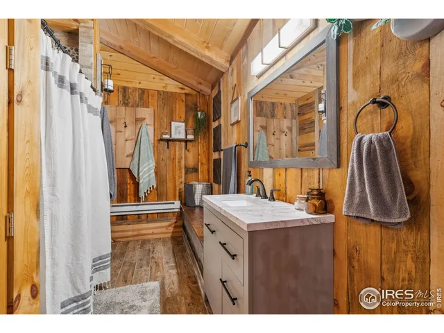 a bathroom with a sink a mirror and a shower