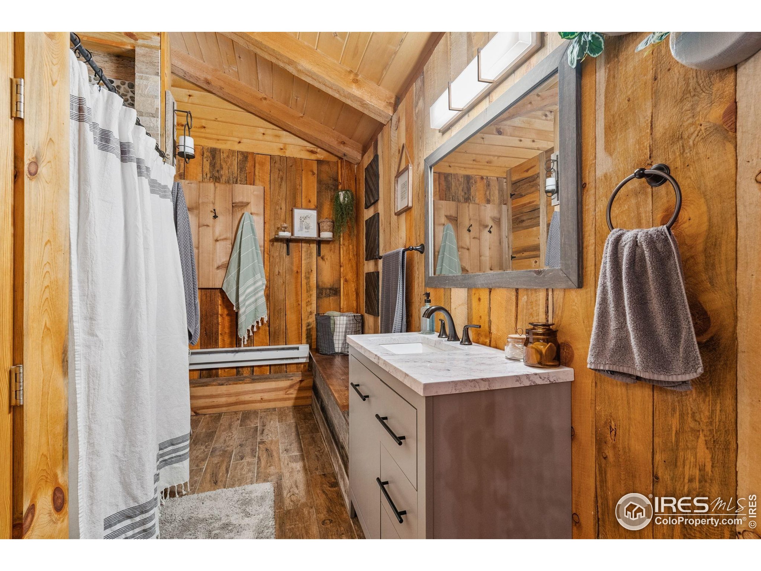 32224 Poudre Canyon Road Bellvue, CO 80512 - Photo 23 of 34 a bathroom with a sink a mirror and a shower