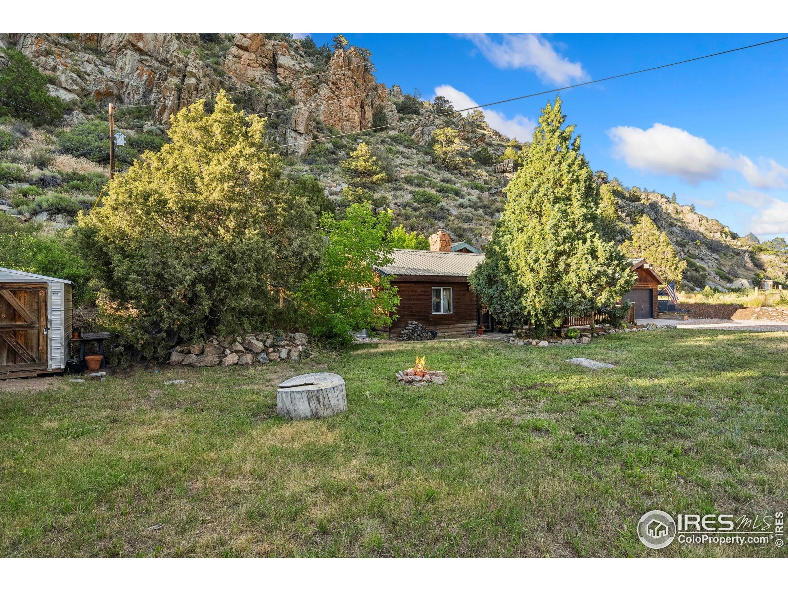 32224 Poudre Canyon Road Bellvue, CO 80512 - Photo 4 of 34 a view of a garden with lawn chairs