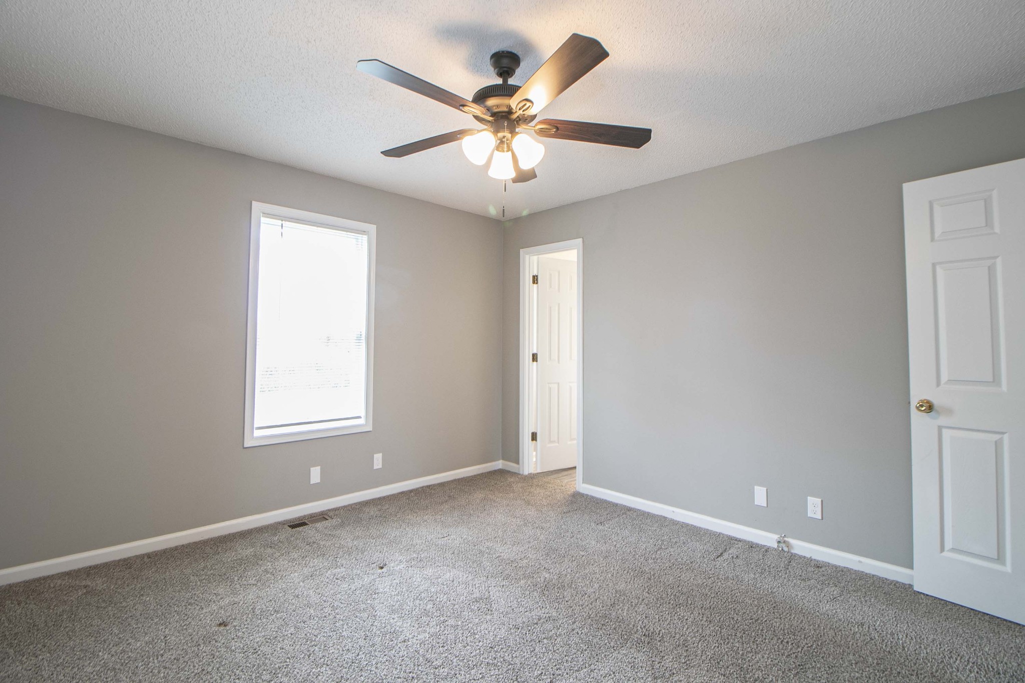 1913 Timberline Circle Oak Grove, KY 42262 - Photo 19 of 25 an empty room with window and ceiling fan