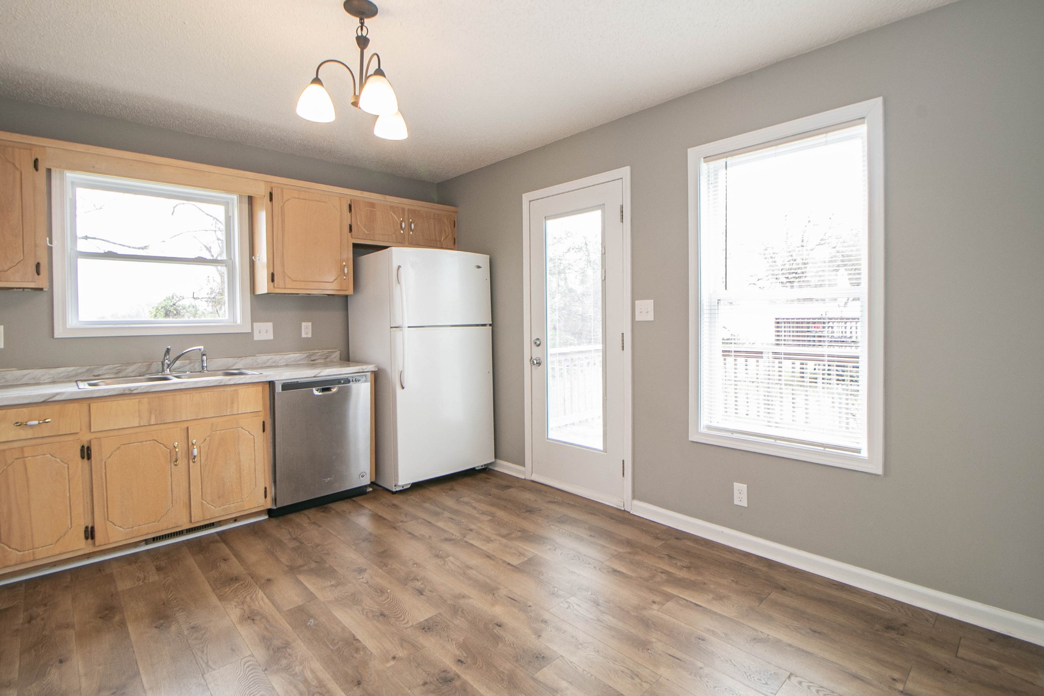 1913 Timberline Circle Oak Grove, KY 42262 - Photo 6 of 25 a kitchen with a refrigerator a sink cabinets and wooden floor