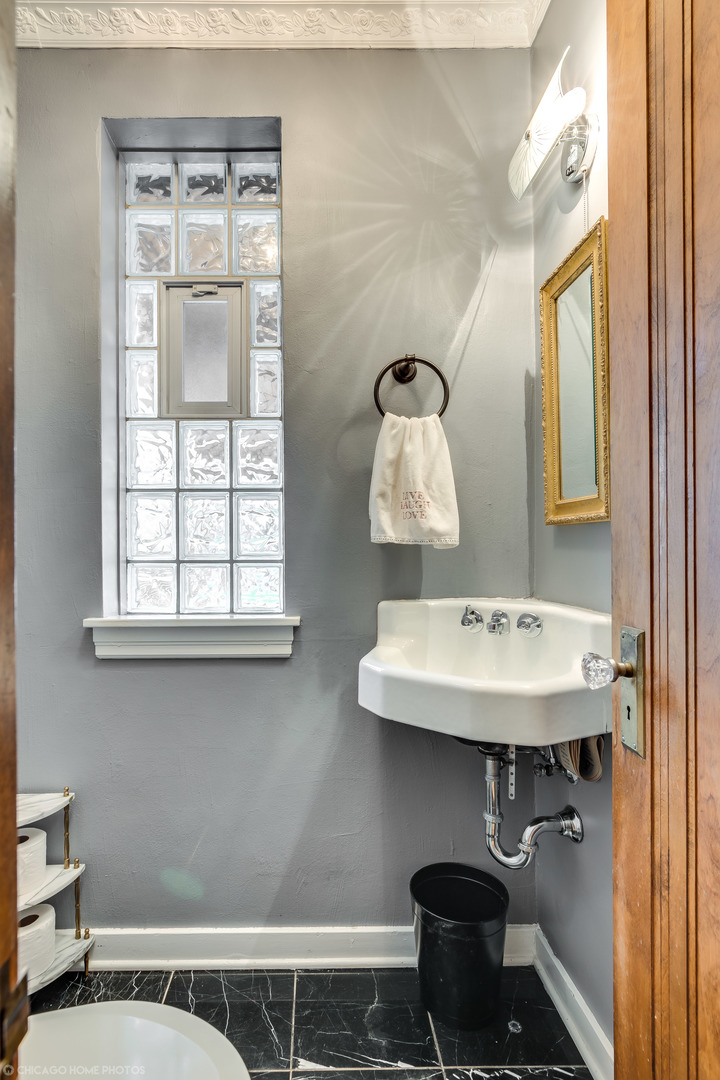 583 Selborne Road Riverside, IL 60546 - Photo 13 of 28 a bathroom with a sink a toilet and mirror