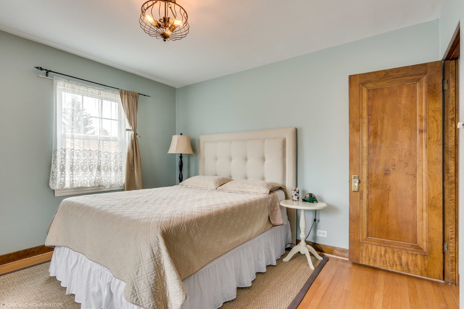 583 Selborne Road Riverside, IL 60546 - Photo 17 of 28 a bedroom with a bed and a chandelier