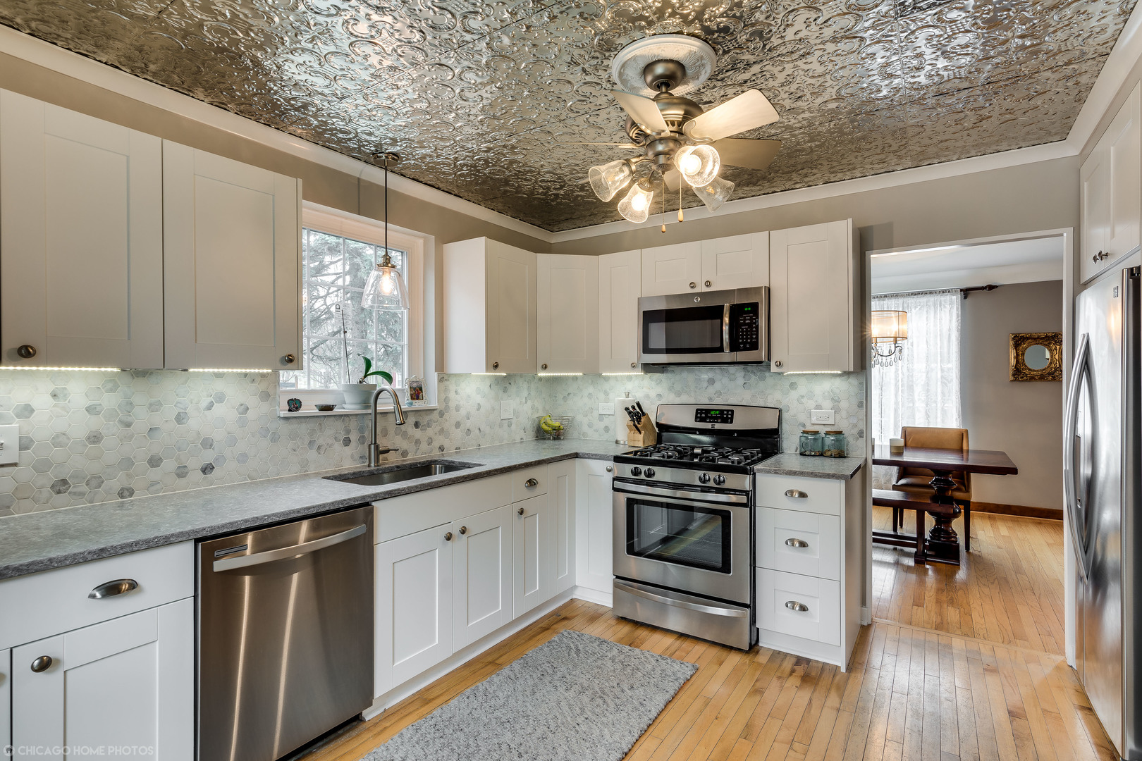 583 Selborne Road Riverside, IL 60546 - Photo 3 of 28 a kitchen with a sink stainless steel appliances cabinets and a window