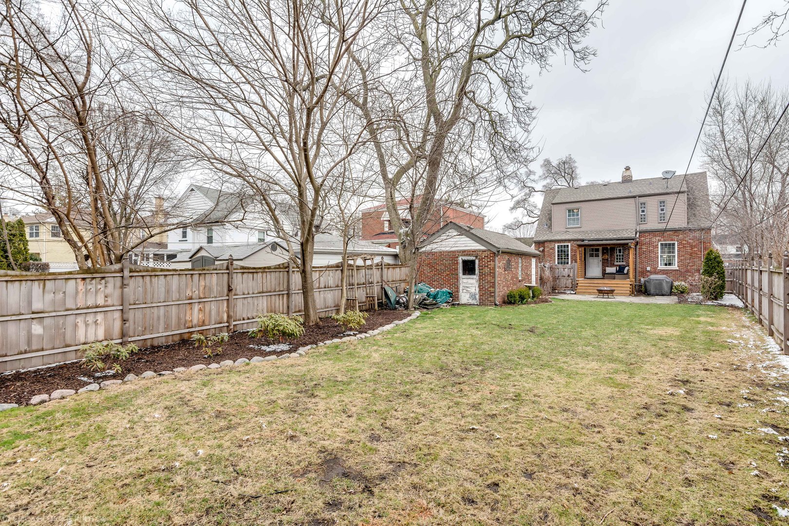583 Selborne Road Riverside, IL 60546 - Photo 24 of 28 a view of a yard in front of a brick house with large windows