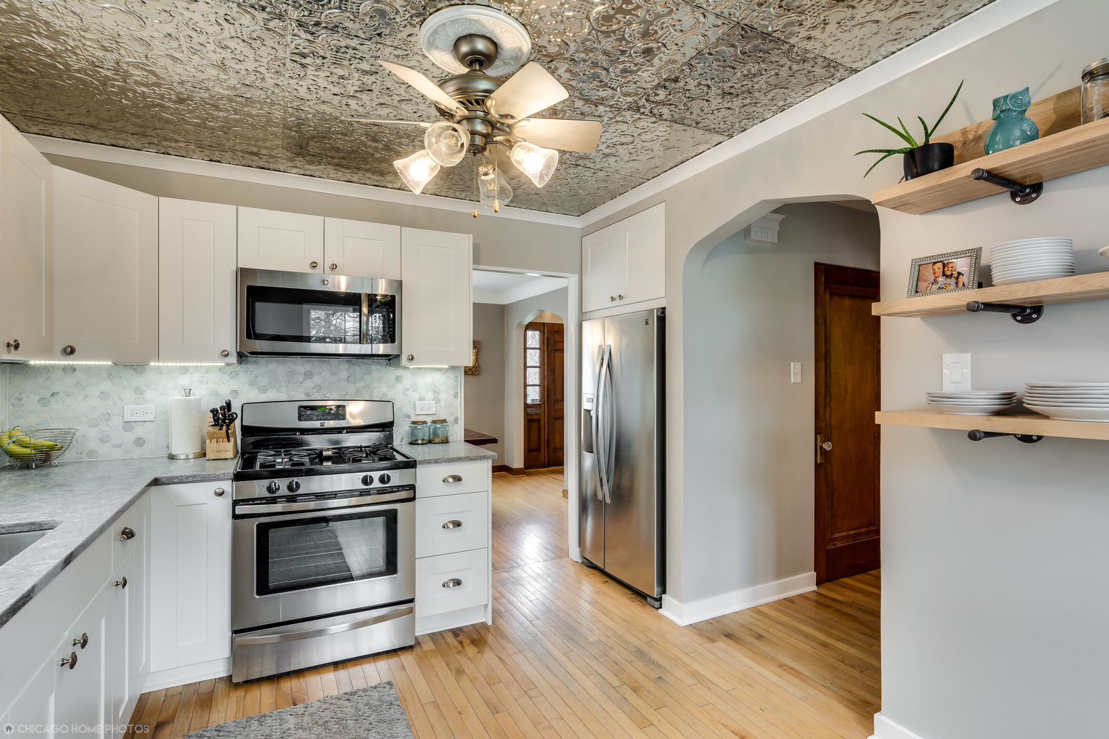 583 Selborne Road Riverside, IL 60546 - Photo 6 of 28 a kitchen with stainless steel appliances a refrigerator a stove a microwave and cabinets