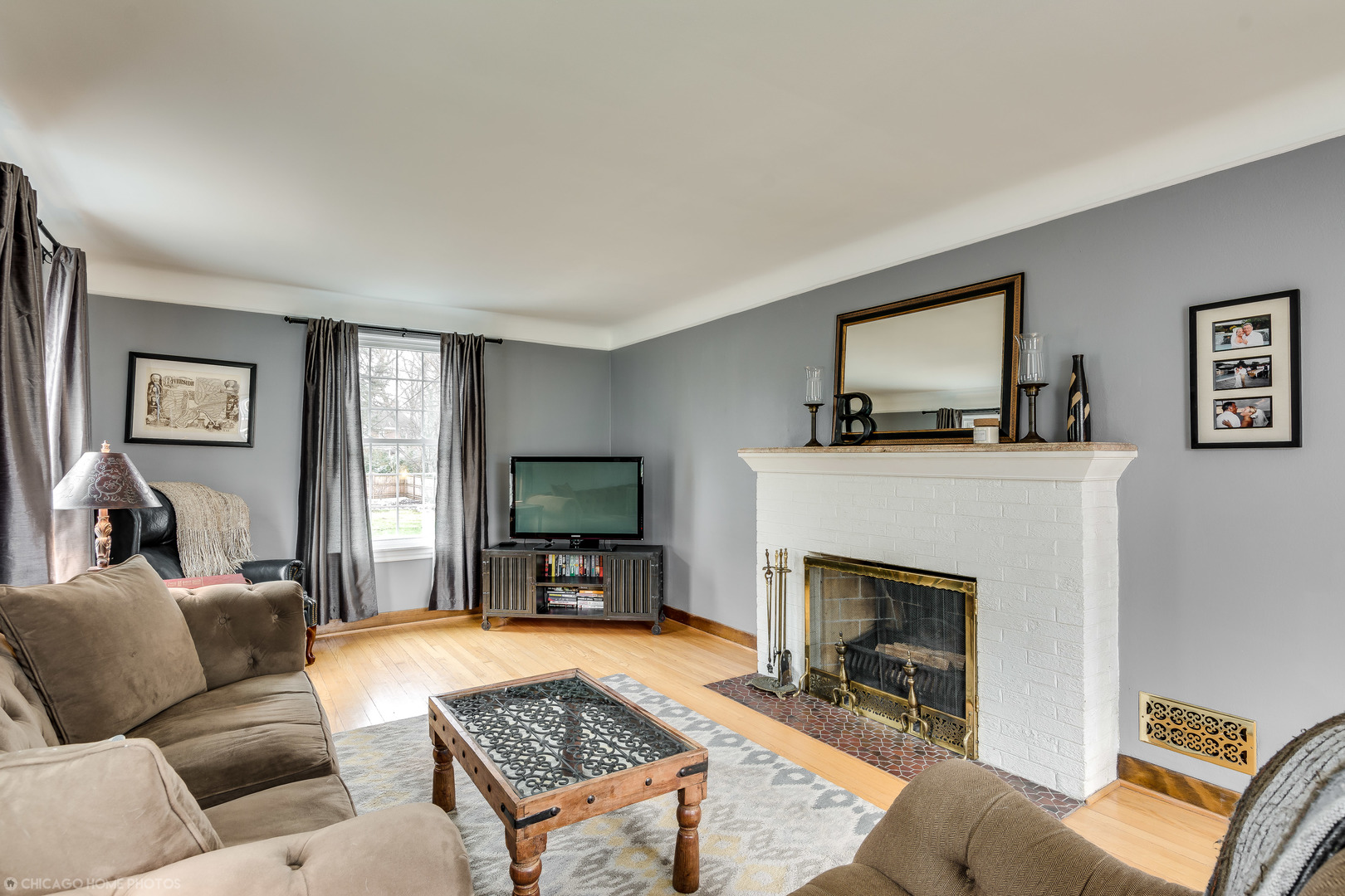 583 Selborne Road Riverside, IL 60546 - Photo 8 of 28 a living room with furniture a flat screen tv and a fireplace