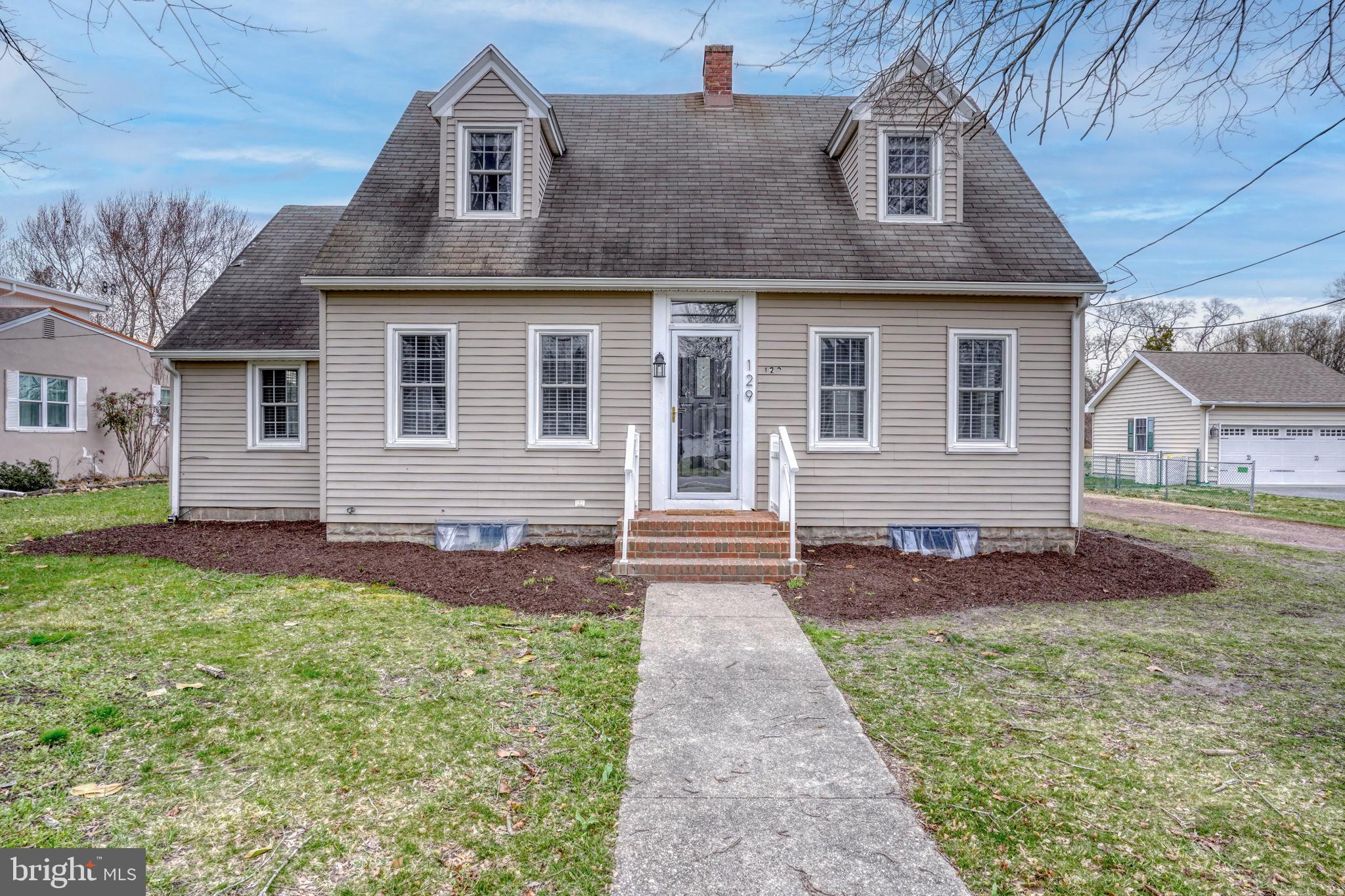 129 Laurel Road Millsboro, DE 19966 - Photo 1 of 40 a front view of a house with yard