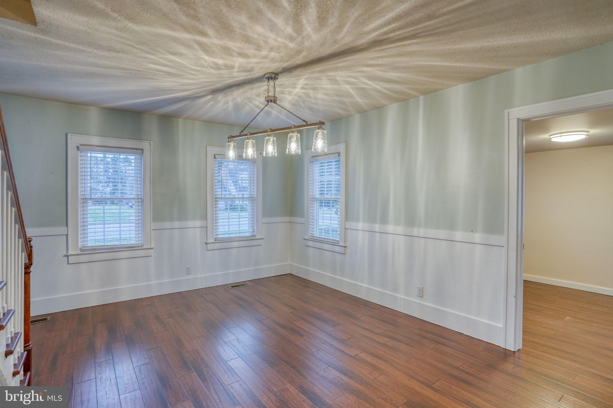 129 Laurel Road Millsboro, DE 19966 - Photo 12 of 40 an empty room with wooden floor and windows