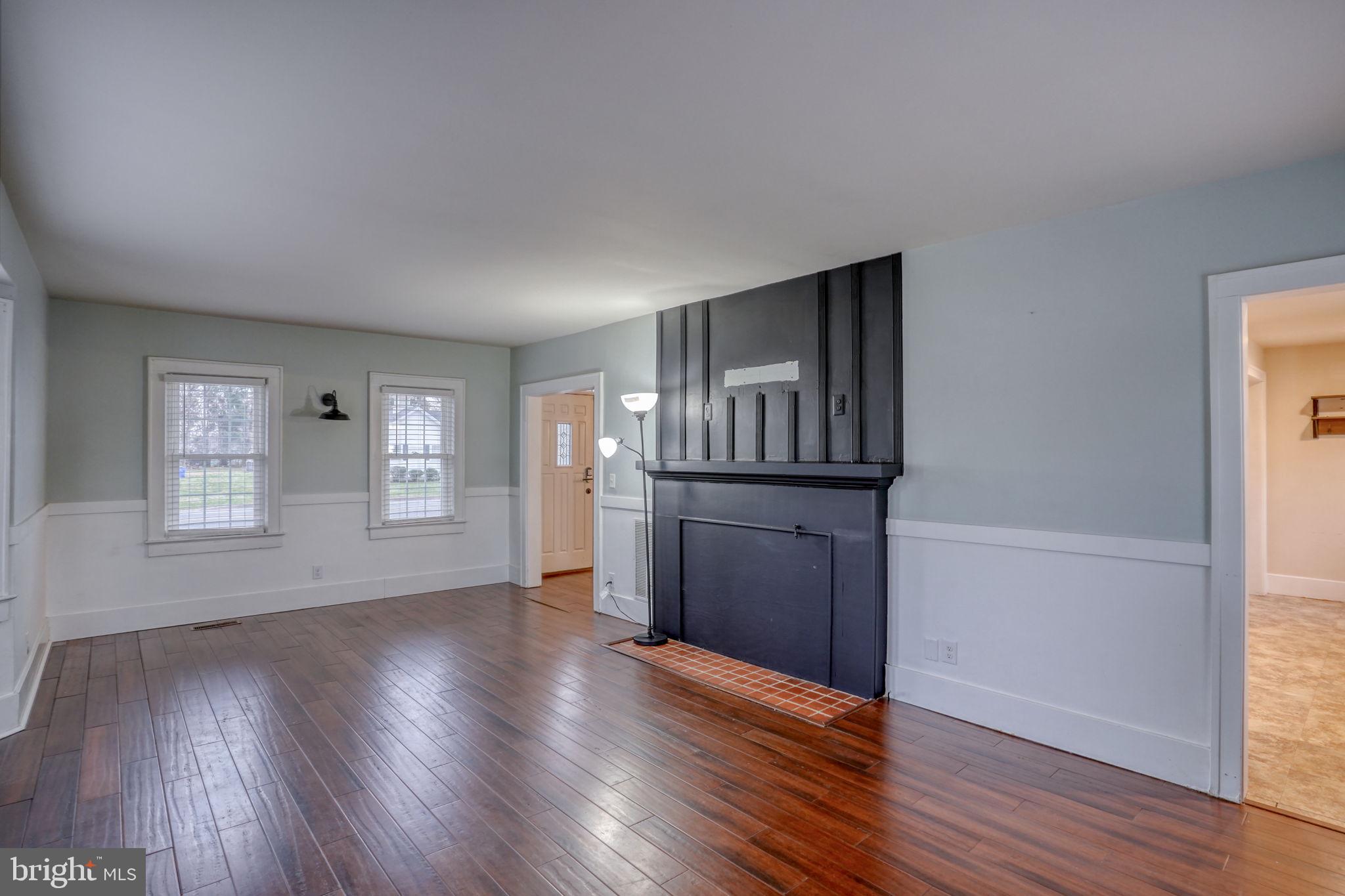 129 Laurel Road Millsboro, DE 19966 - Photo 21 of 40 an empty room with wooden floor and windows