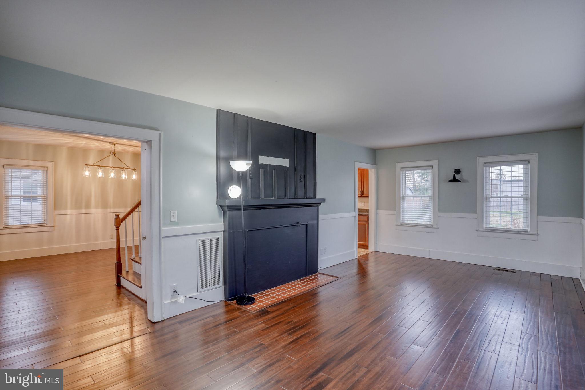 129 Laurel Road Millsboro, DE 19966 - Photo 22 of 40 an empty room with wooden floor and windows