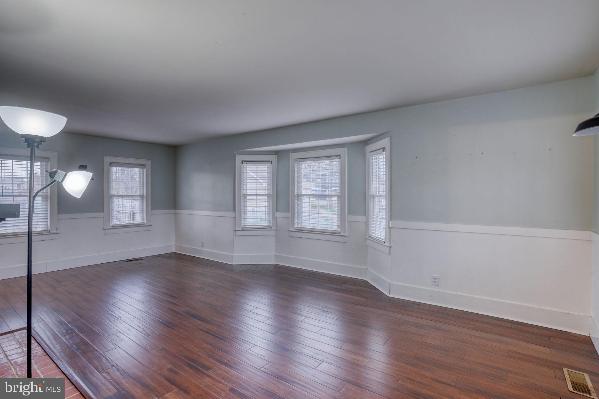 129 Laurel Road Millsboro, DE 19966 - Photo 24 of 40 a view of wooden floor and windows in an empty room
