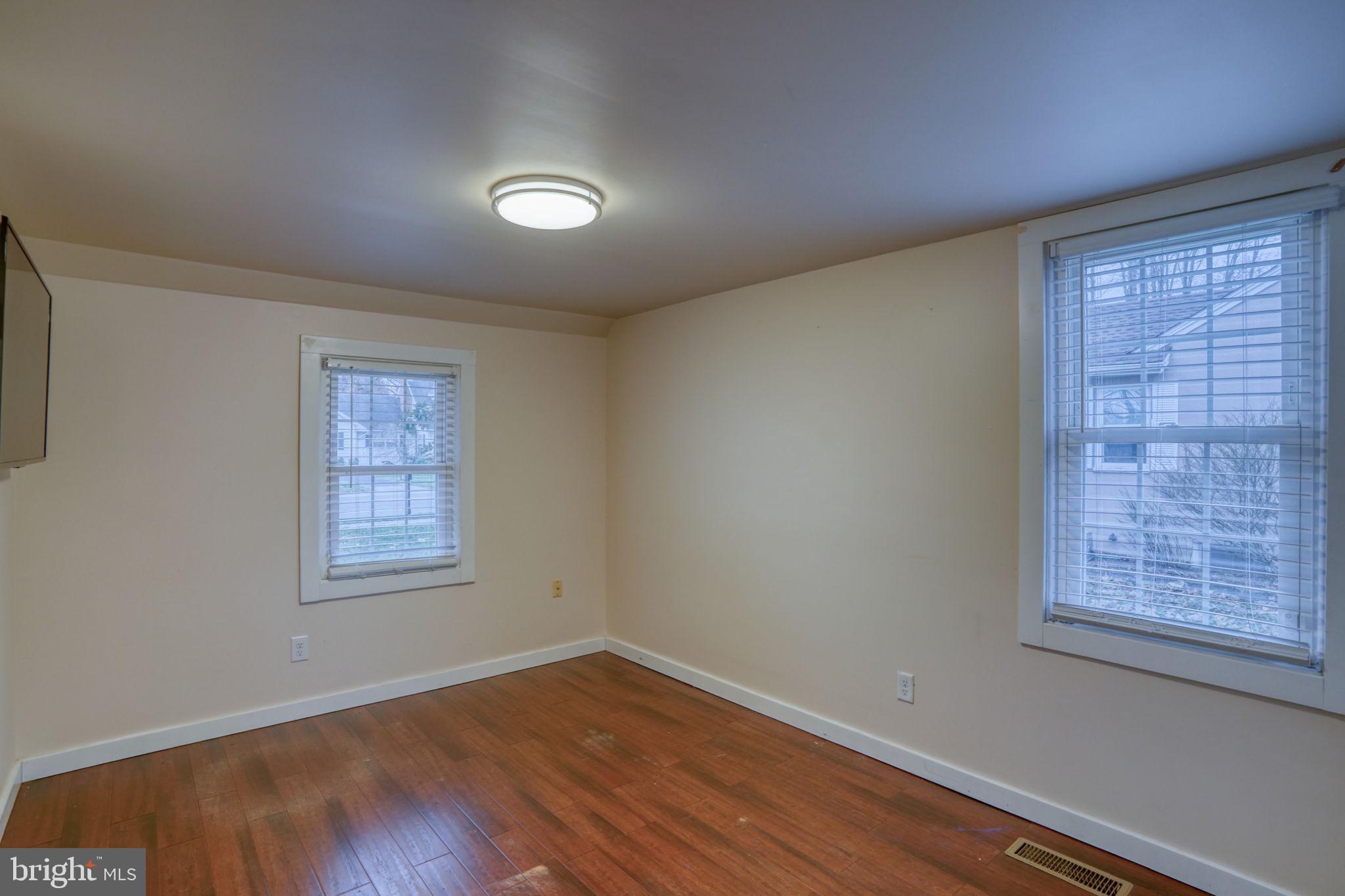 129 Laurel Road Millsboro, DE 19966 - Photo 25 of 40 a view of an empty room with wooden floor and a window
