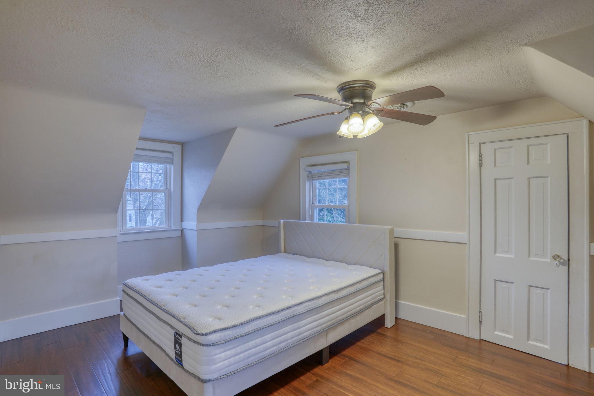 129 Laurel Road Millsboro, DE 19966 - Photo 28 of 40 a bedroom with a bed and a chandelier