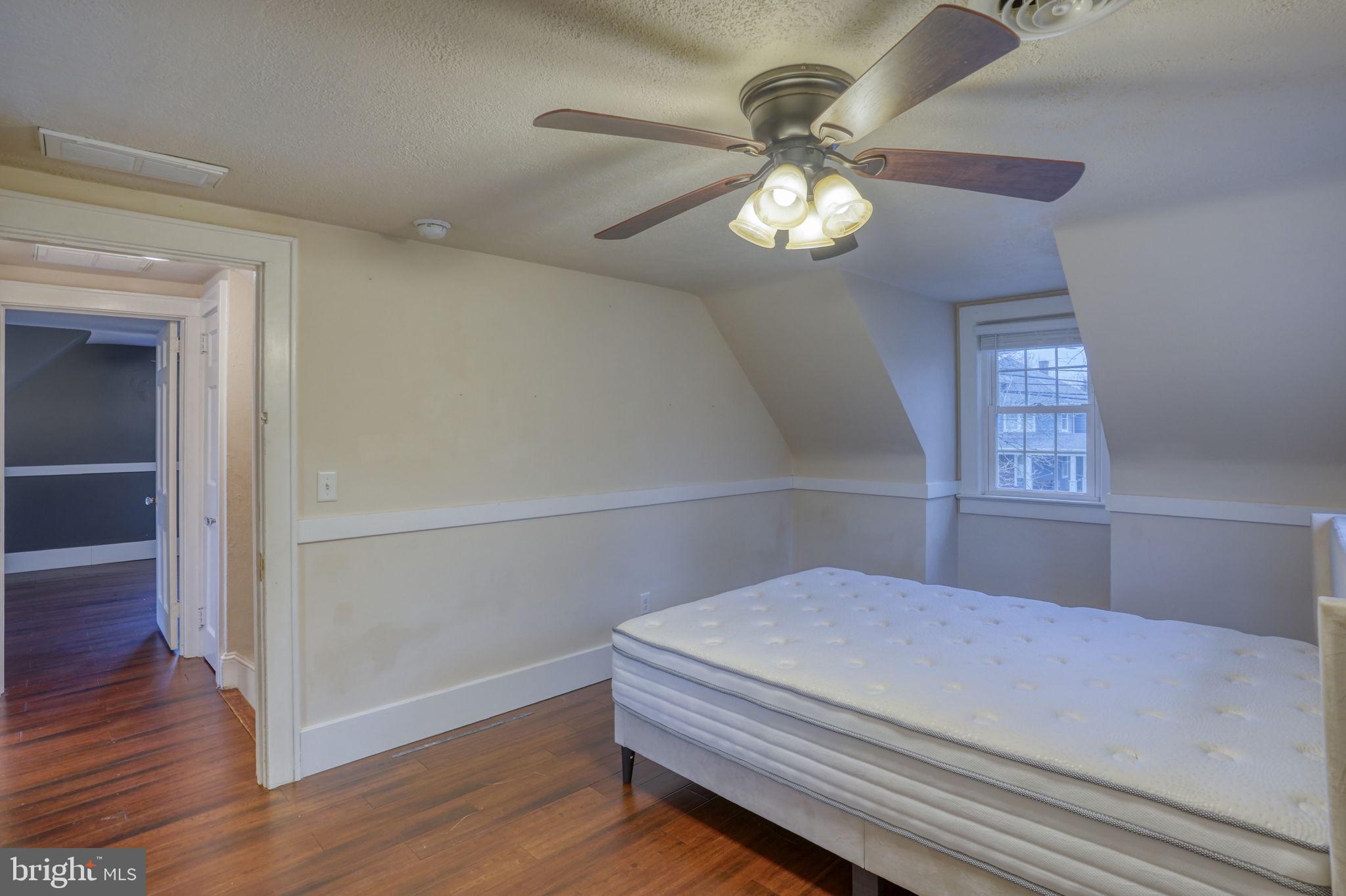129 Laurel Road Millsboro, DE 19966 - Photo 29 of 40 a bedroom with a bed and a chandelier