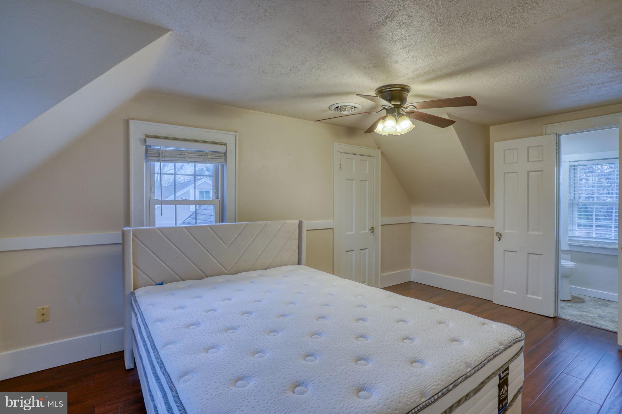 129 Laurel Road Millsboro, DE 19966 - Photo 30 of 40 a bedroom with a bed and a chandelier