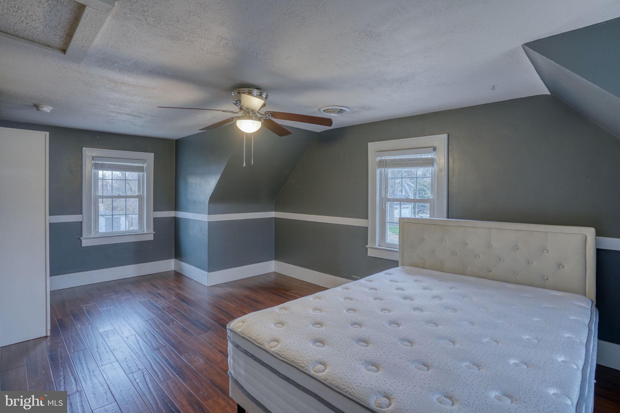 129 Laurel Road Millsboro, DE 19966 - Photo 34 of 40 a bedroom with a bed and a chandelier