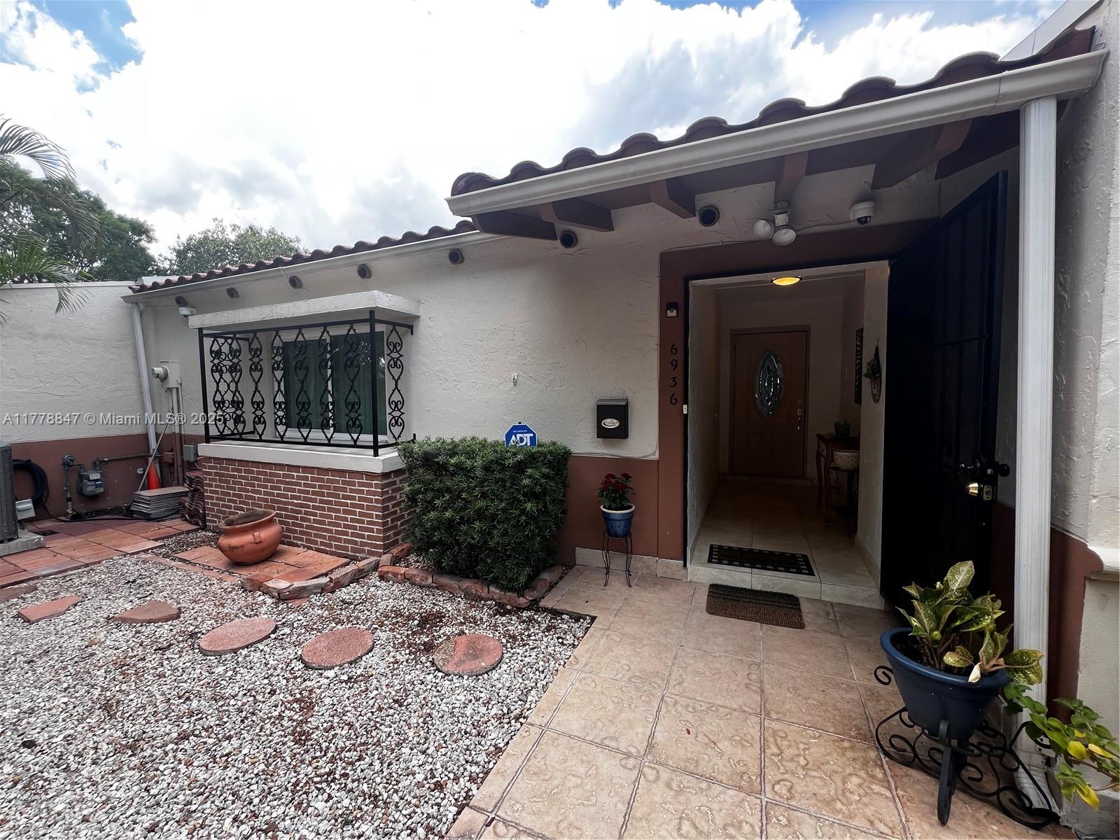 6936 Holly Road Miami Lakes, FL 33014 - Photo 2 of 43 Charming courtyard entry welcomes you home.