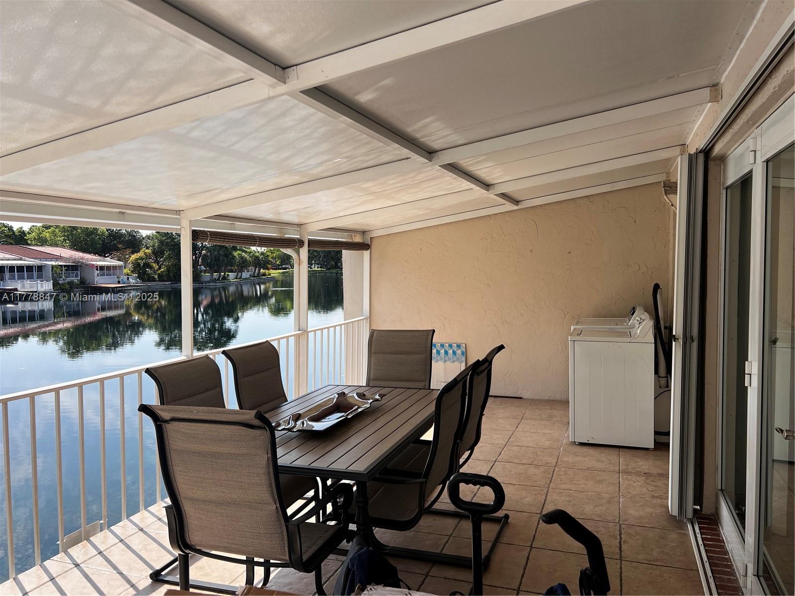 6936 Holly Road Miami Lakes, FL 33014 - Photo 30 of 43 Rear covered deck with peaceful view to Lake Martha.