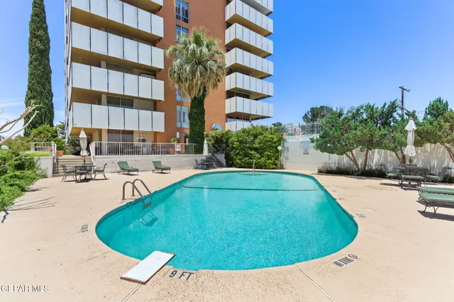 a kitchen with kitchen island a sink stove and refrigerator
