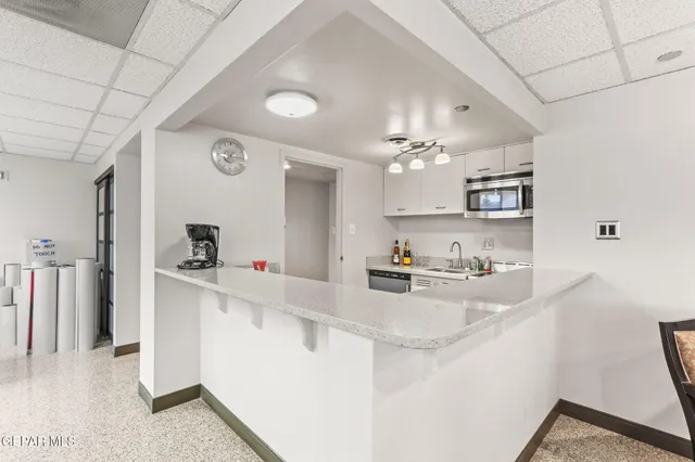 a bathroom with a granite countertop sink and mirror