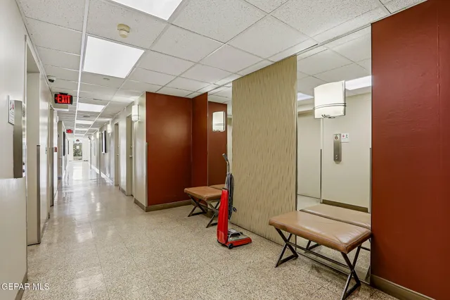 a bedroom with a bed and a large mirror